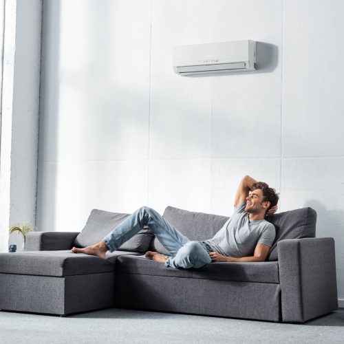 handsome-and-smiling-man-in-jeans-and-t-shirt-lying-on-sofa.jpg