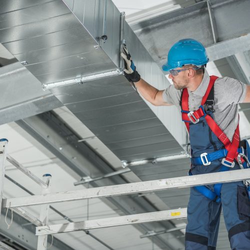 professional-technician-worker-finishing-newly-assembled-air-vent-shaft.jpg